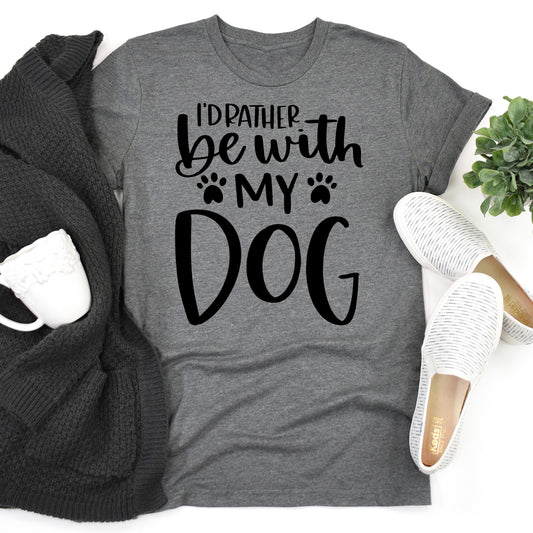  Gray t-shirt with black text "I'd Rather Be With My Dog" and paw print accents, flat lay with sweater and shoes.