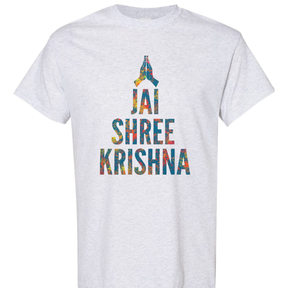 Light gray t-shirt with an illustration of folded hands in a "Namaste" gesture and the phrase "JAI SHREE KRISHNA" in bold letters with a colorful, textured pattern. "Jai Shree Krishna" is a Hindu devotional chant and a common greeting in Gujarat. Cotton blend t-shirts, available in various sizes.