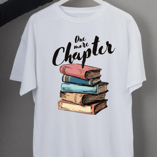 White t-shirt with a stack of colorful books and "Just One More Chapter" text.  A perfect gift for book lovers and avid readers.