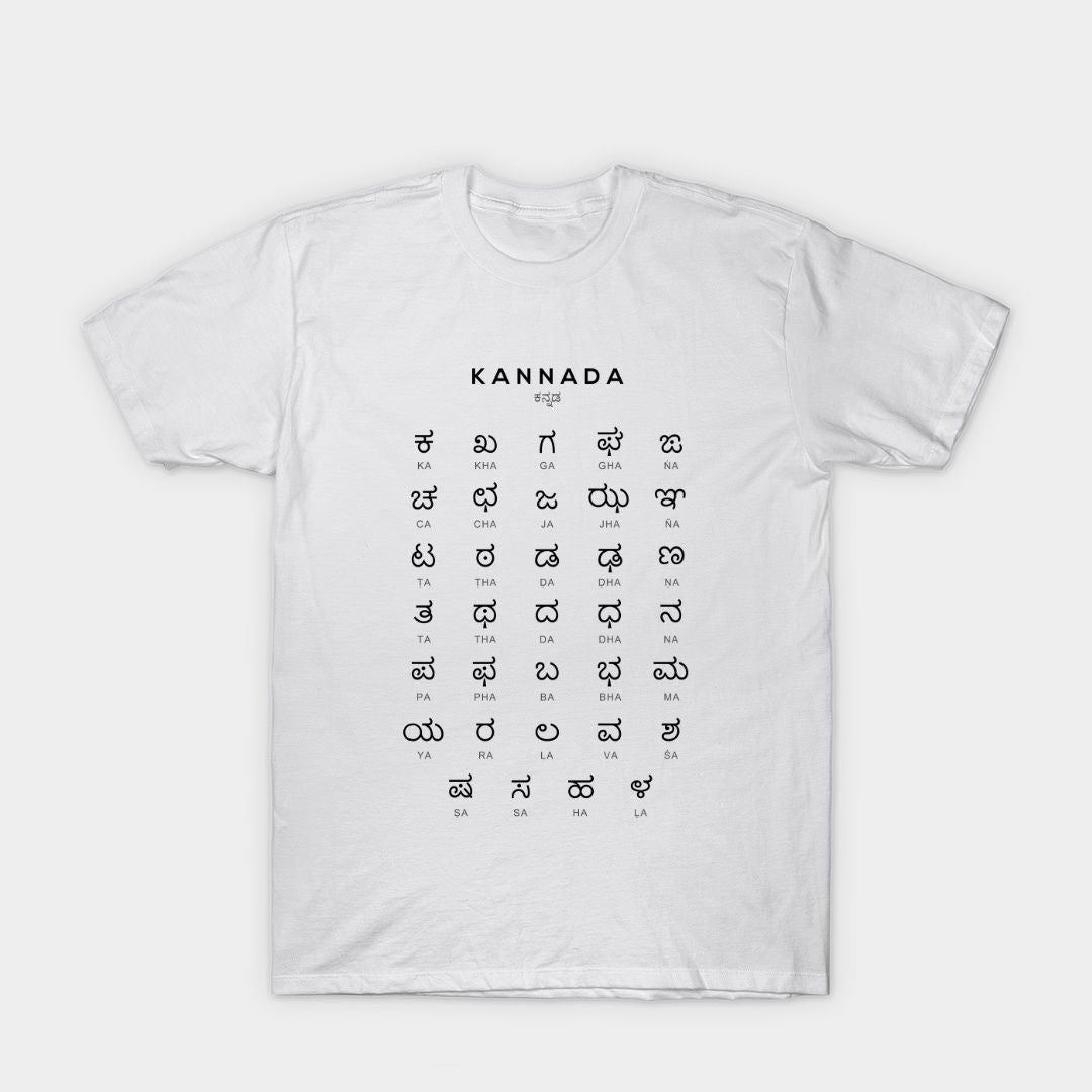 White t-shirt with the Kannada alphabet printed in a grid format, including both the Kannada script and Roman transliteration.