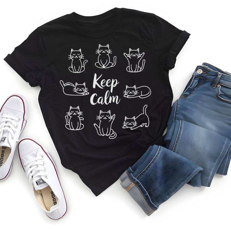 Black T-Shirt featuring the text "Keep Calm" surrounded by various illustrations of cute cats in different poses.