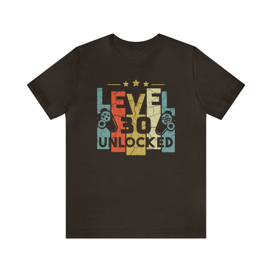 Dark brown t-shirt featuring "Level 30 Unlocked" in a pixelated design with controller graphics.  Distressed retro style, ideal for a gamer's 30th birthday.
