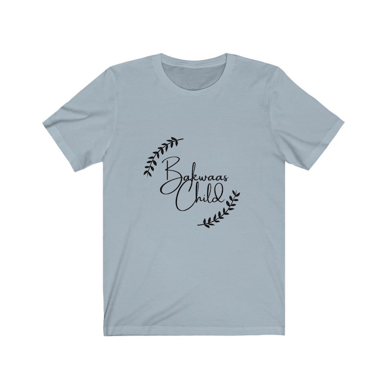 Light t-shirt featuring the text "Bakwaas Child" in a stylish font, accompanied by leaf graphics.
