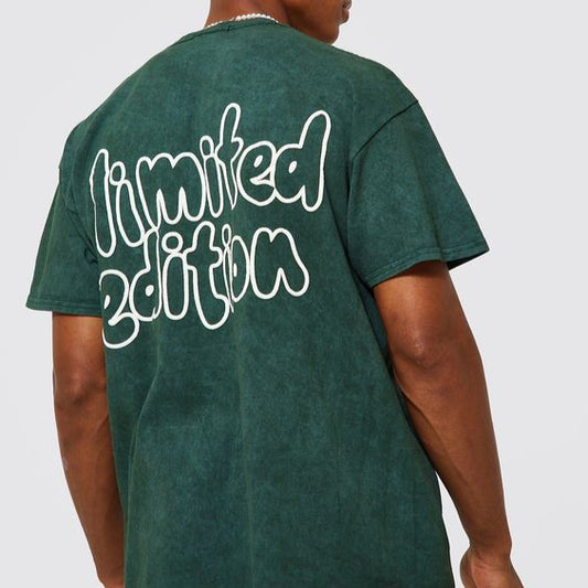 Dark green oversize t-shirt with "Limited Edition" text in a white, outlined, script-like font on the back. The shirt has a slightly faded or washed-out appearance, suggesting a vintage or distressed style.