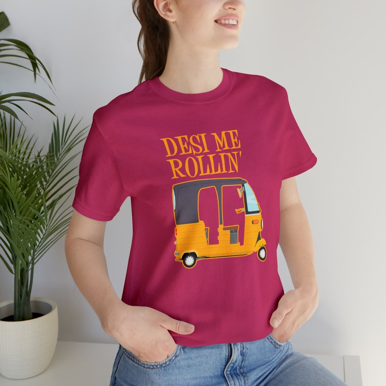 A smiling woman models a maroon t-shirt with a yellow auto rickshaw graphic and the text "Desi Me Rollin'".