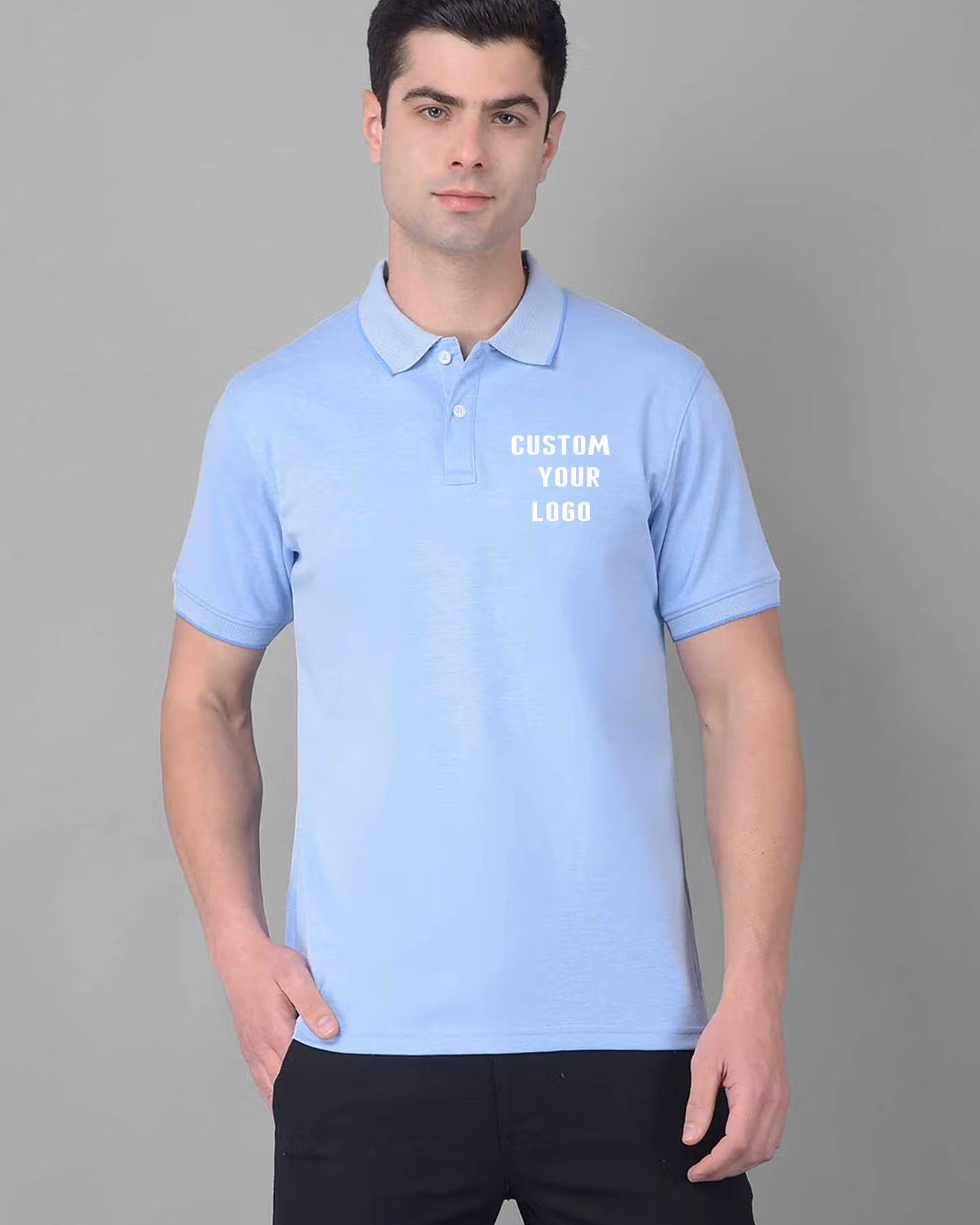 A men poses in a light blue polo t-shirt displaying the text "CUSTOM YOUR LOGO".