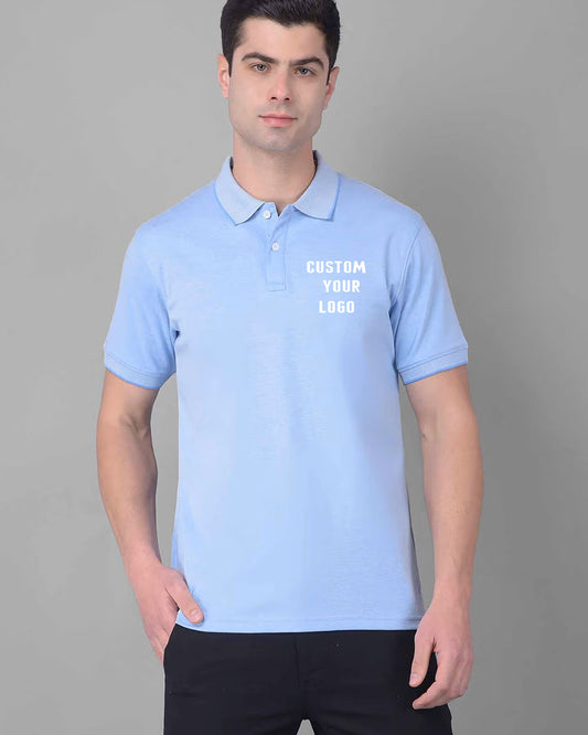 A men poses in a light blue polo t-shirt displaying the text "CUSTOM YOUR LOGO".