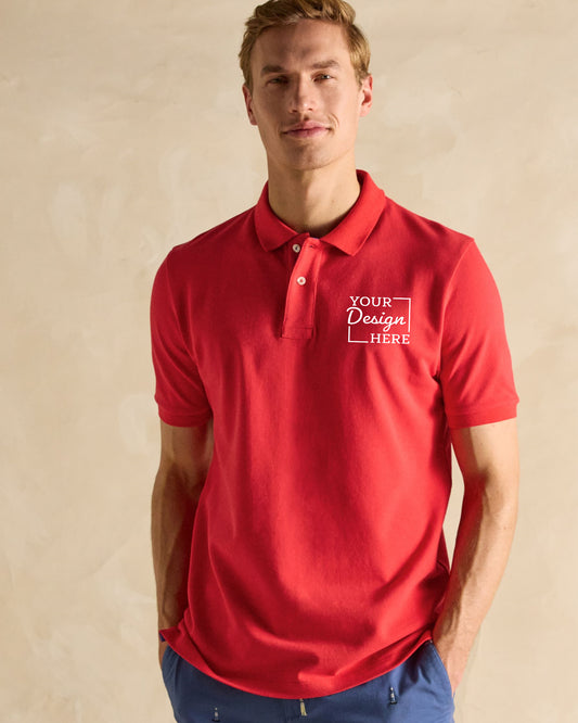 A men models a red short-sleeved polo t-shirt featuring "YOUR Design HERE" within a white box outline.