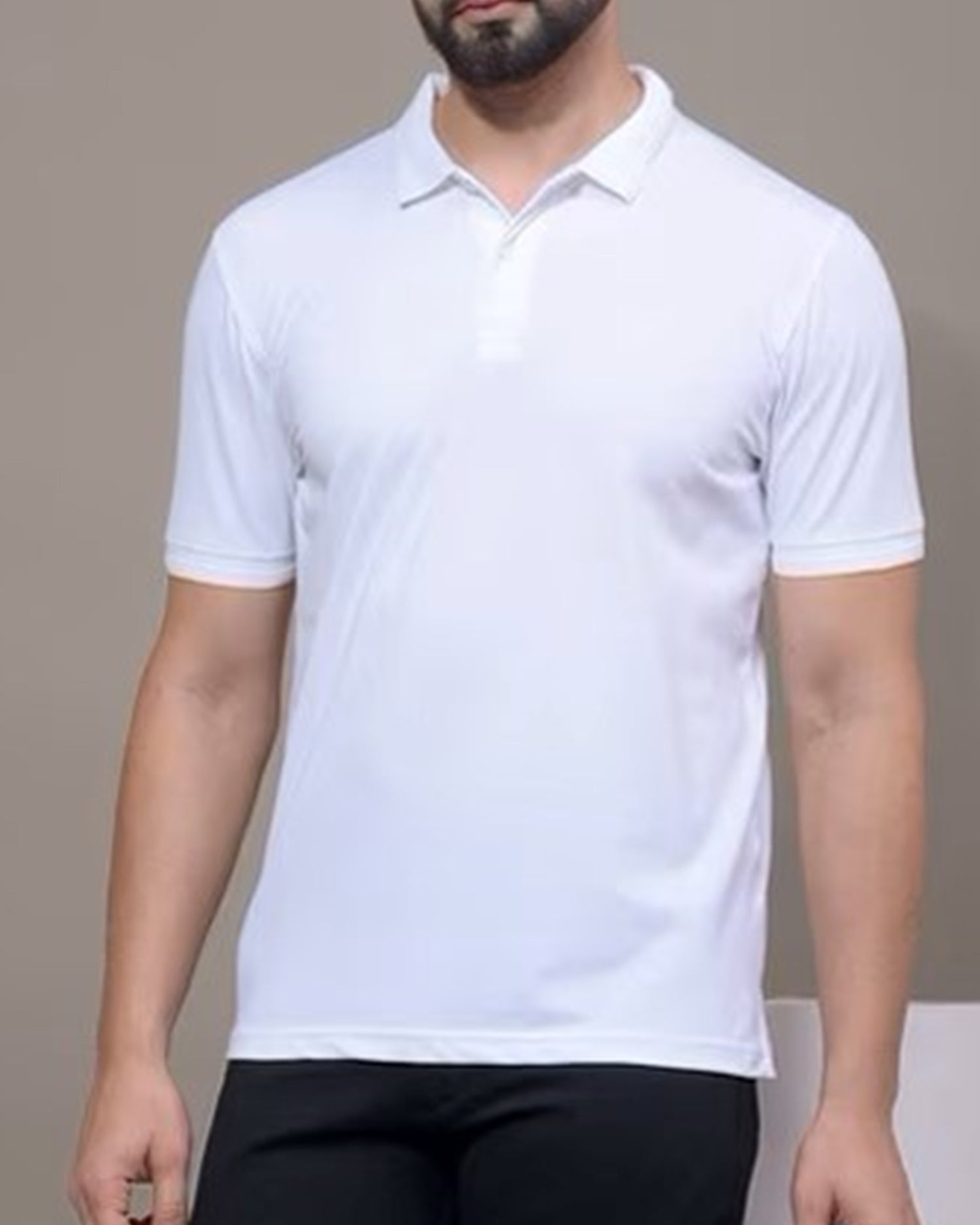 A men with a beard models a plain white short-sleeved polo t-shirt.