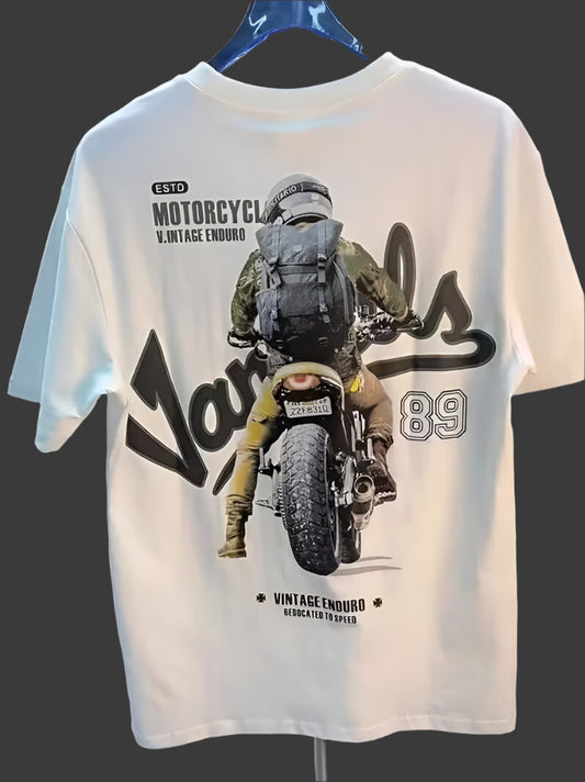 White t-shirt with a graphic of a motorcyclist wearing a backpack, riding a motorcycle from behind, with text "ESTD MOTORCYCL V.INTAGE ENDURO", "Vandals 89", and "VINTAGE ENDURO DEDICATED TO SPEED".
