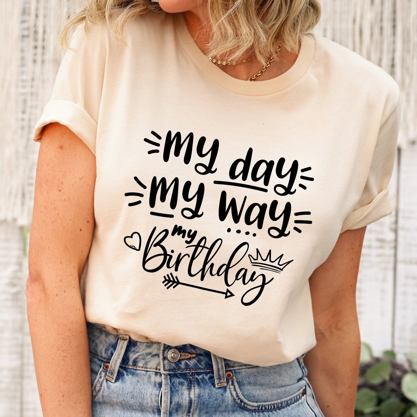 Cream t-shirt with "My Day My Way" and "My Birthday" in black script, featuring a crown and arrow. Comfortable, stylish birthday apparel.
