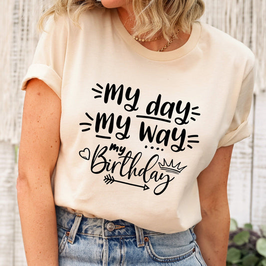 Cream t-shirt with "My Day My Way" and "My Birthday" in black script, featuring a crown and arrow. Comfortable, stylish birthday apparel.