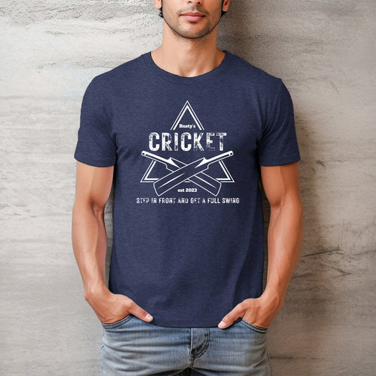 A man models a navy blue t-shirt with a white graphic featuring cricket bats and the text "Rusty's Cricket".