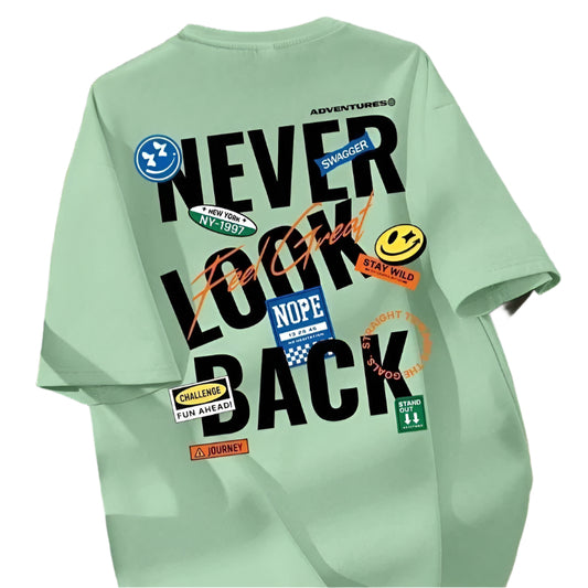Light green oversized t-shirt with "Never Look Back" text and various graphic patches on the back.