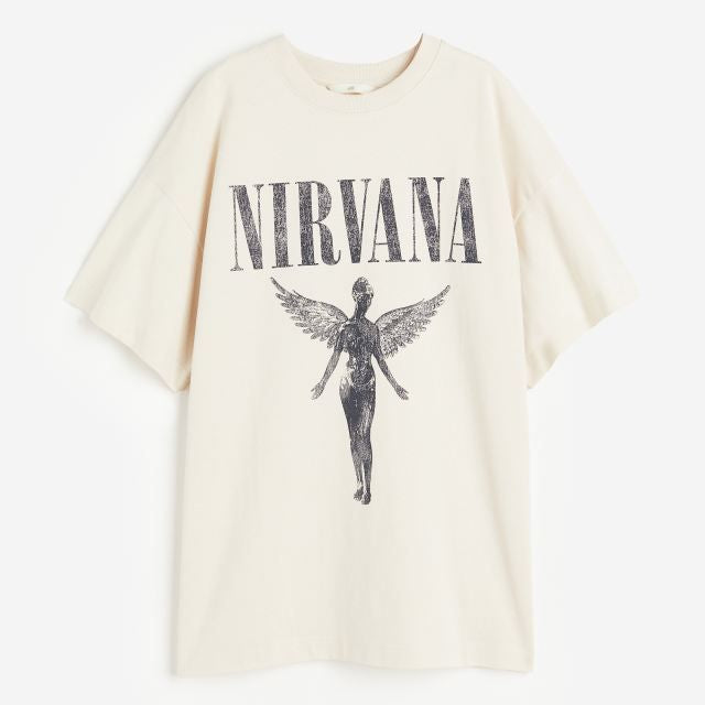 Light-colored t-shirt with "NIRVANA" text above a graphic of the winged angel from the band Nirvana's "In Utero" album cover.
