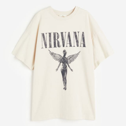 Light-colored t-shirt with "NIRVANA" text above a graphic of the winged angel from the band Nirvana's "In Utero" album cover.
