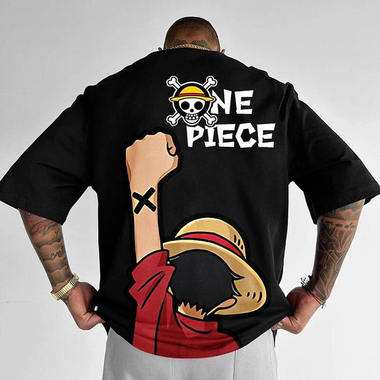 Dark-colored oversize t-shirt with a graphic of Monkey D. Luffy's back, wearing his signature straw hat and red shirt, with his fist raised. The "One Piece" logo is printed above him.