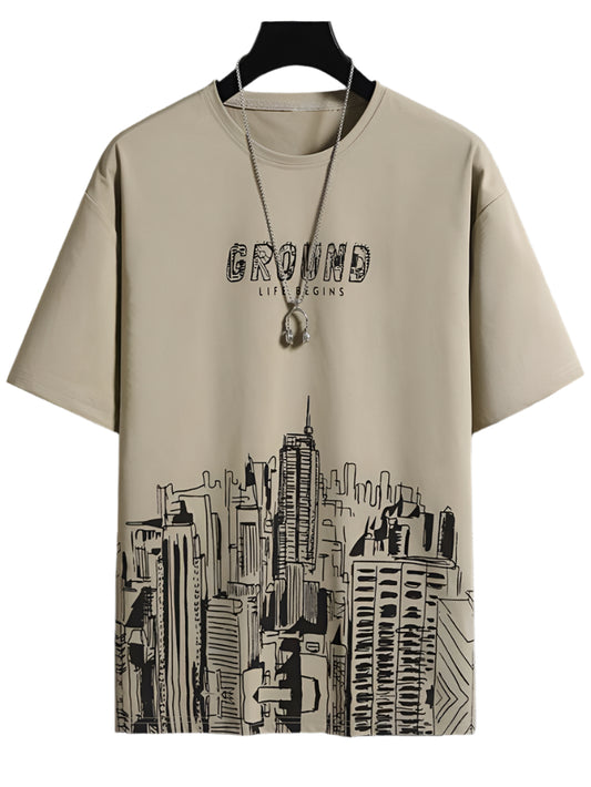 Beige men's t-shirt with black graphic print of a cityscape and the phrase "GROUND LIFE BEGINS" on the chest.