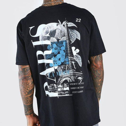 Dark-colored oversize t-shirt with "Paris" text, an Eiffel Tower and floral graphic, and French text on the back.