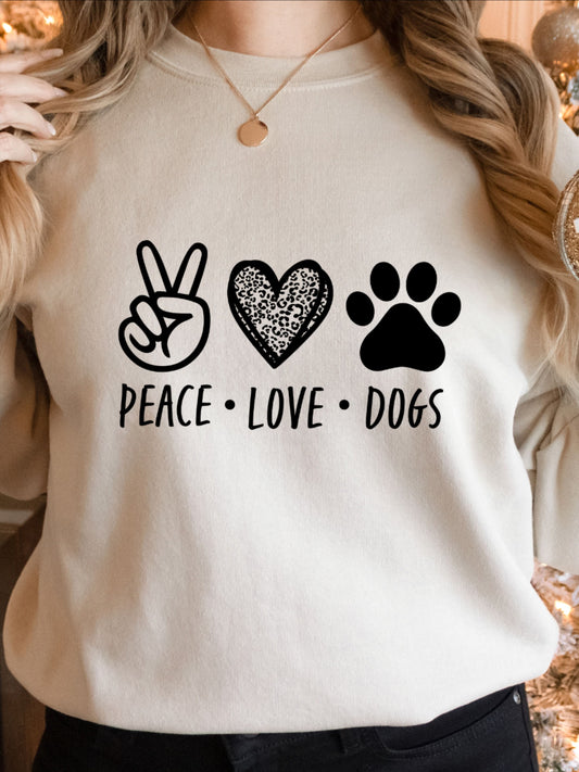  A light-colored t-shirt with "Peace Love Dogs" graphic featuring a peace sign, heart, and paw print.