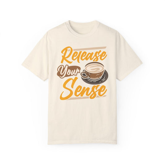 Light beige t-shirt with "Release Your Sense" text and a coffee cup graphic. A simple design for coffee enthusiasts.