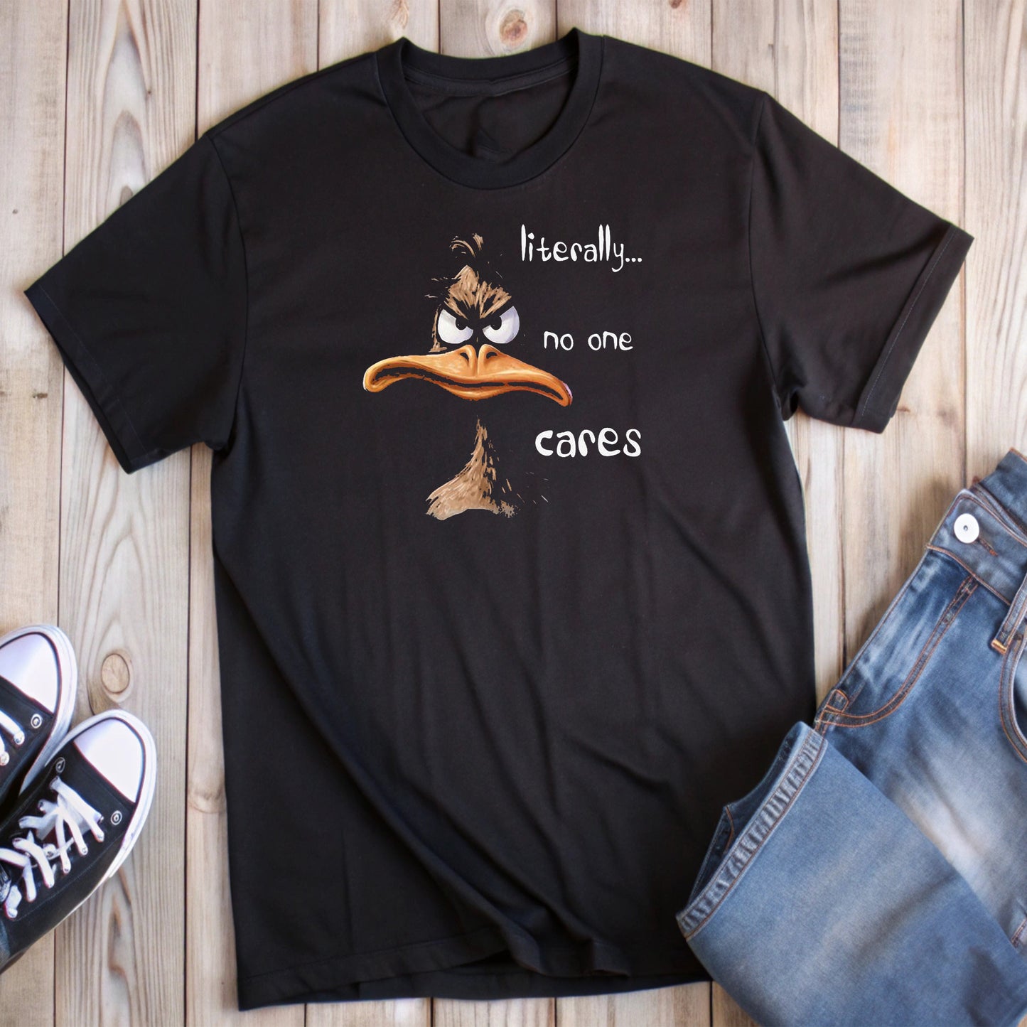Black t-shirt featuring an annoyed Daffy Duck cartoon face with the text "literally... no one cares".