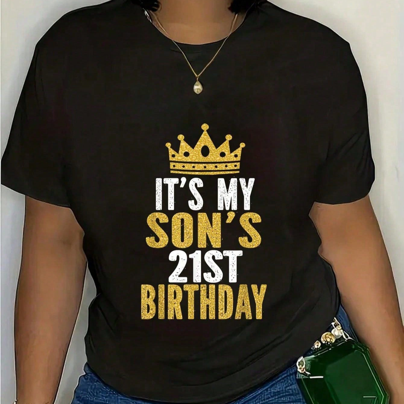 Black t-shirt with "It's My Son's 21st Birthday" in gold glitter lettering, featuring a crown.  A celebratory piece for a proud parent.