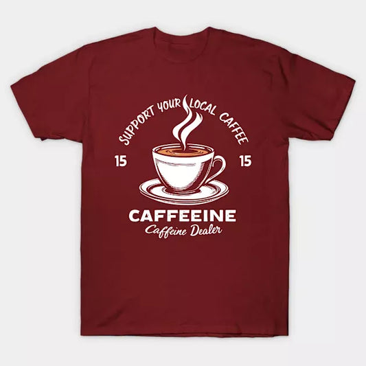 Maroon t-shirt with "Support Your Local Caffee" text and a coffee cup graphic. A stylish design for coffee enthusiasts.
