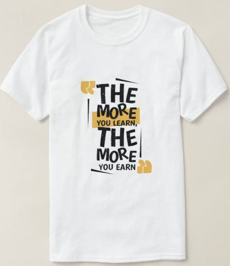 White t-shirt with "The More You Learn, The More You Earn" text in a bold, stylized font and yellow accents. A motivational design for learners and achievers.