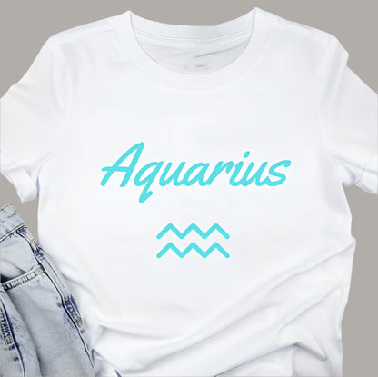 White t-shirt displays the word "Aquarius" in teal script above the Aquarius zodiac symbol.