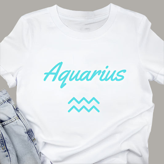 White t-shirt displays the word "Aquarius" in teal script above the Aquarius zodiac symbol.