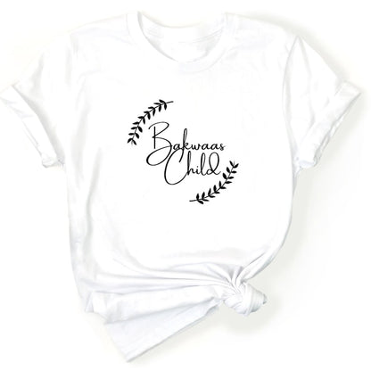 White t-shirt featuring the text "Bakwaas Child" in a stylish font, accompanied by leaf graphics.