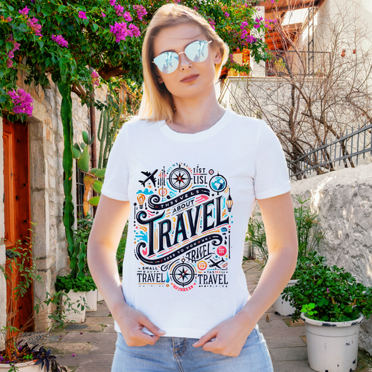 A woman with sunglasses models a white t-shirt featuring vibrant travel-related illustrations and typography.