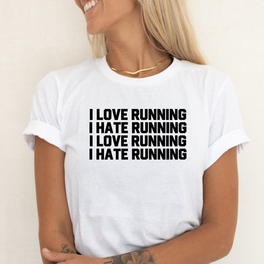 Woman in white t-shirt with "I LOVE RUNNING I HATE RUNNING" text repeated.