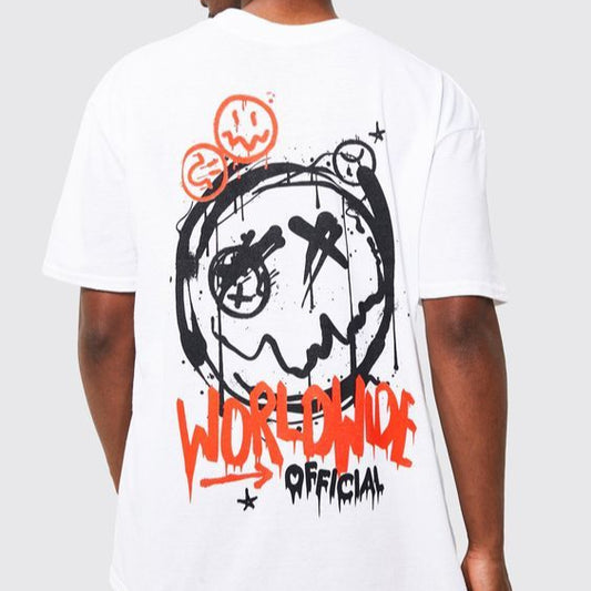 White oversized t-shirt with a black and orange graffiti-style face graphic and "WORLDWIDE OFFICIAL" text on the back.