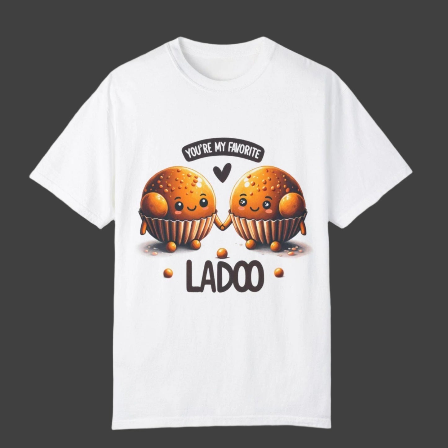 White t-shirt with two cartoon-like ladoos holding hands, the phrase "YOU'RE MY FAVORITE" in a speech bubble, and the word "LADOO" below them. Cotton blend t-shirts, available in various sizes.