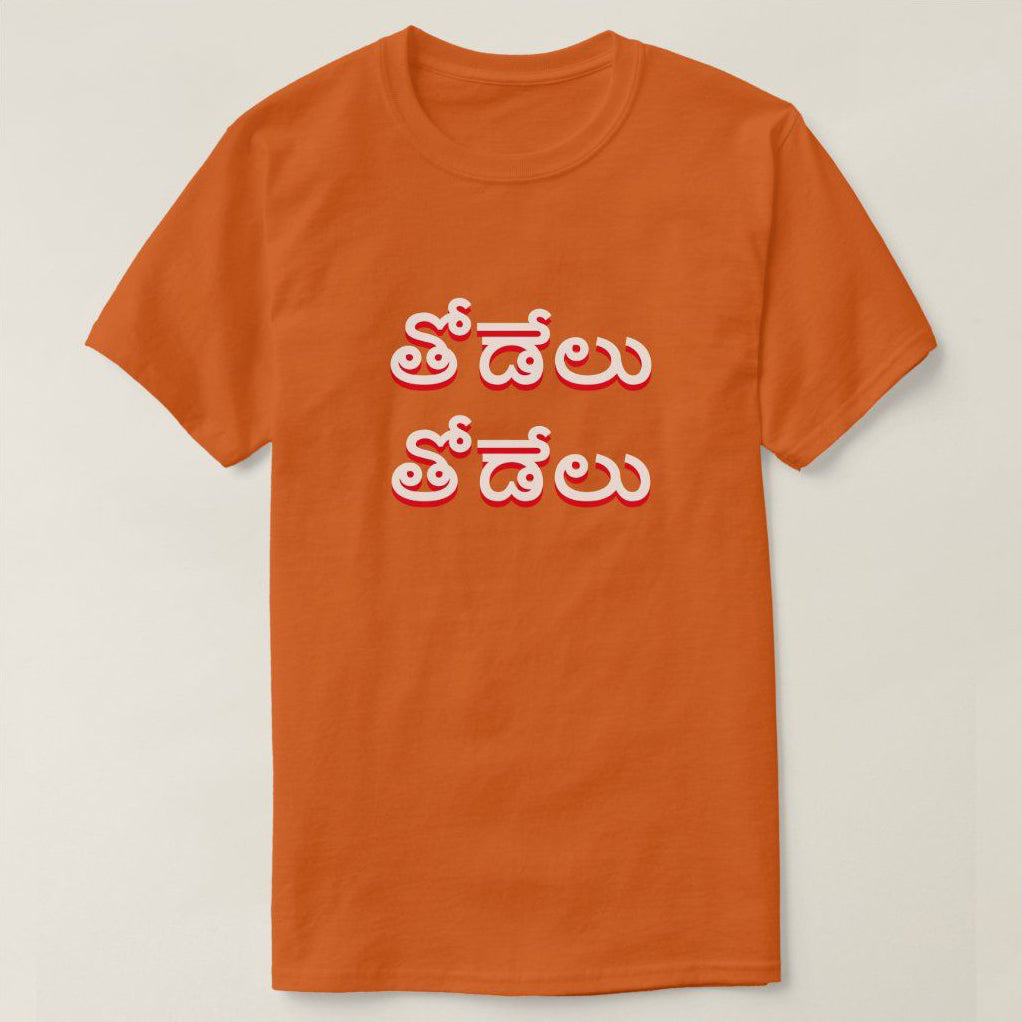 Orange t-shirt with the Telugu phrase 'Thodelu Thodelu' (Wolf Wolf) printed in white and red.  Bold design expressing strength or a symbolic meaning on a comfortable t-shirt.