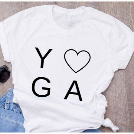 White t-shirt with "YOGA" text, heart symbol, sunglasses & jeans.