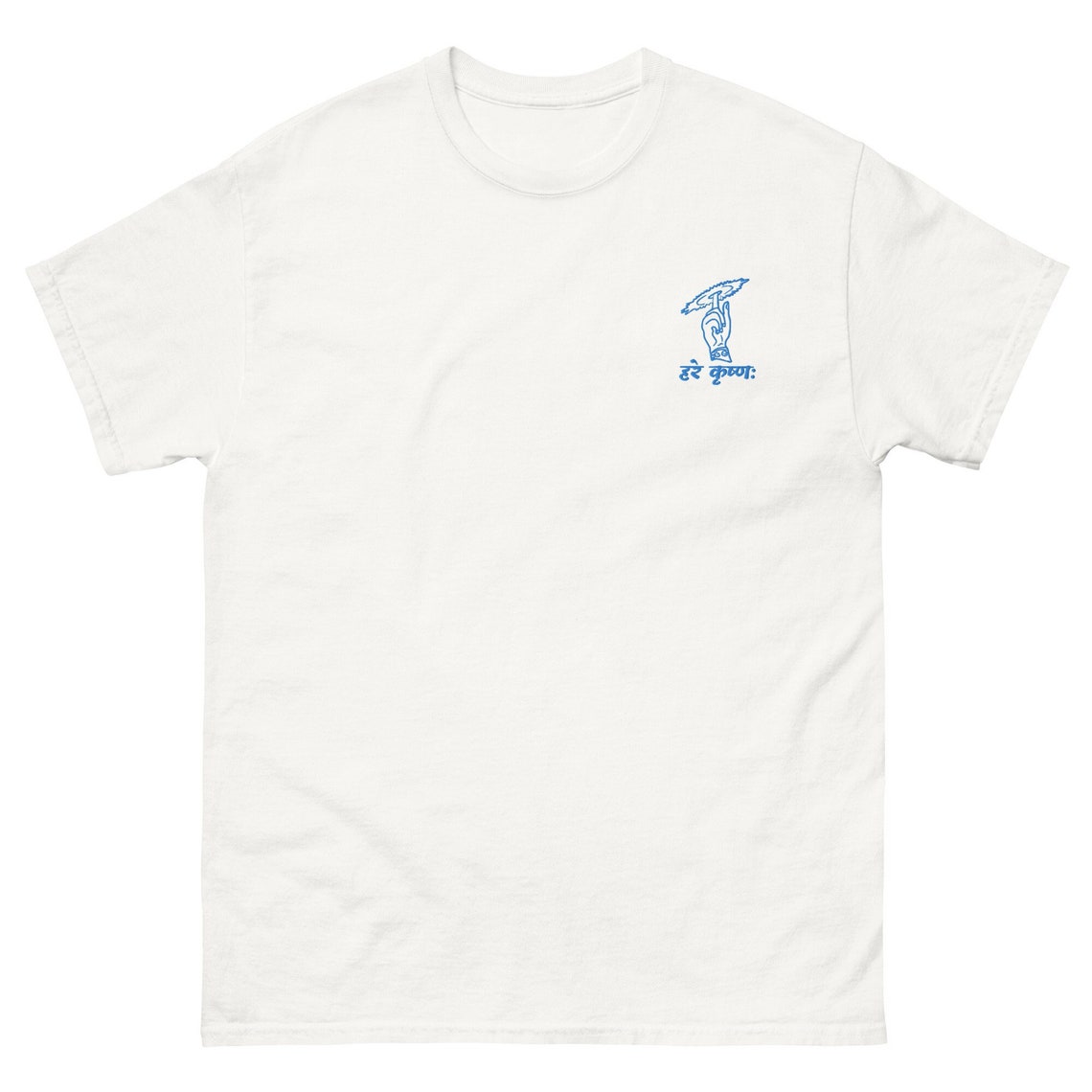 White t-shirt with a small blue line drawing of a hand holding a flute and the "Hare Krishna" mantra in Devanagari script on the left chest.