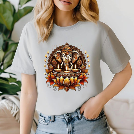 A light grey t-shirt featuring a Ganesha, lotus, and diya design, radiating divine blessings and light.
