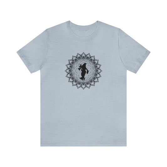 Light blue jersey tee with a black silhouette of Krishna playing flute within a detailed mandala design.