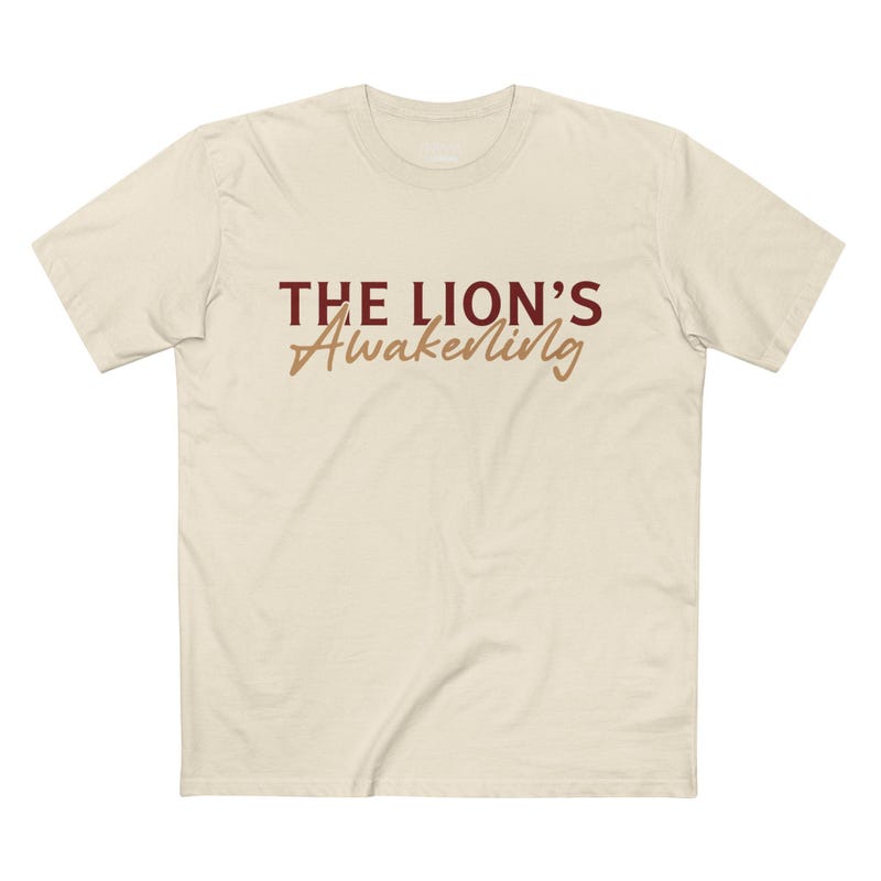 A light-colored t-shirt with "The Lion's Awakening" in bold lettering, conveying a message of inner strength.