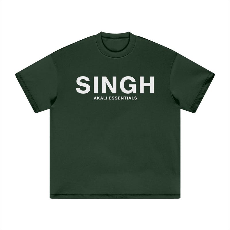 A dark green t-shirt with "Singh" and "Akali Essentials," representing Sikh pride and a timeless sense of style.