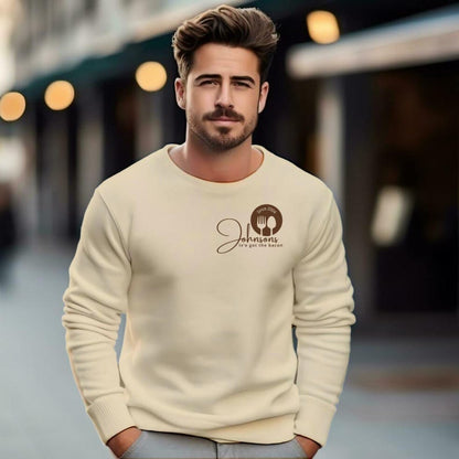 man stand close cream sweatshirts with a small logo on the chest.